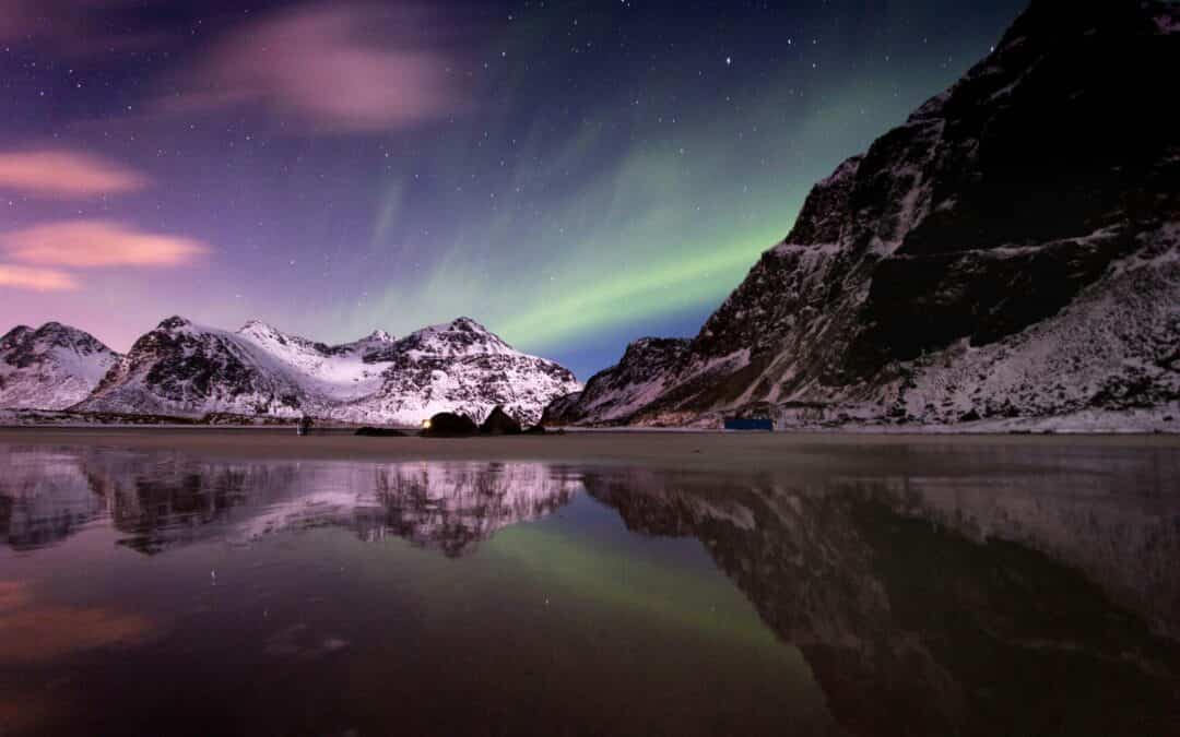 Northern lights over a mountain range at night